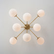 Load image into Gallery viewer, Brass 8-Light Milky Glass Globe Sunburst Semi Flush Mount
