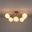Load image into Gallery viewer, Brass 8-Light Milky Glass Globe Sunburst Semi Flush Mount
