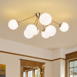 Load image into Gallery viewer, Brass 8-Light Milky Glass Globe Sunburst Semi Flush Mount

